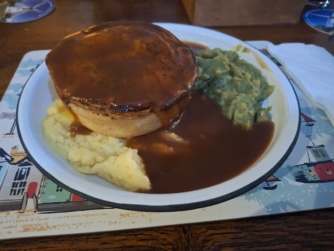 Chicken and mushroom pie with mash and peas